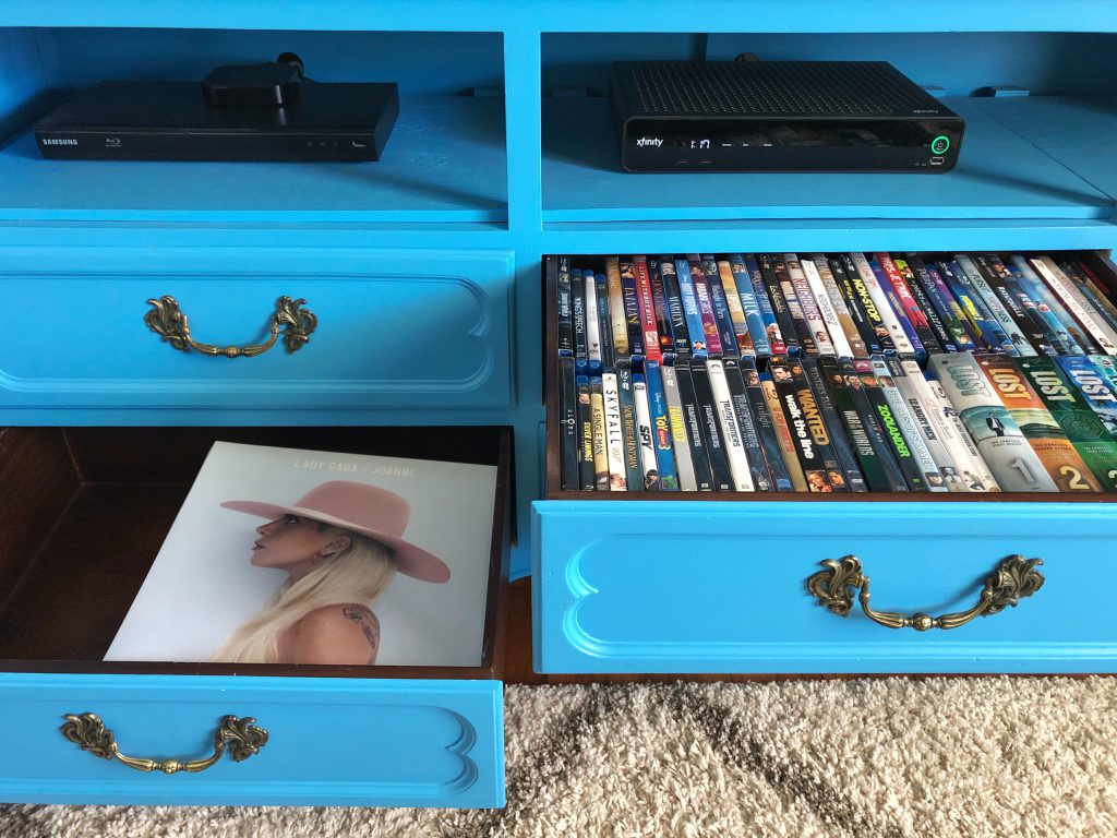 The TV Stand drawers hold DVDs, records, board games, and other thing 